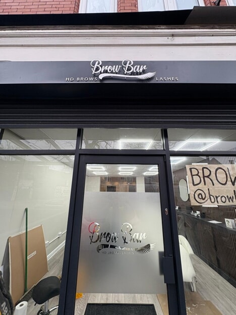 An image of the Brow Bars exterior channel letters and door graphics.
